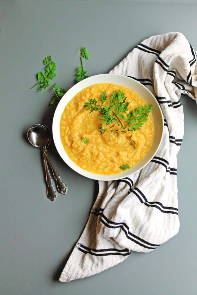 Simple, creamy sweet potato carrot soup! This vegan soup is loaded with fresh herbs and flavor. Perfect for a weeknight meal. Vegan, gluten free, Paleo friendly. So good!