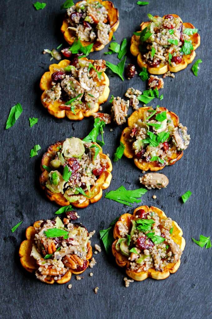 Quinoa stuffed delicata squash rings with mushrooms, cranberries, and pecans! Packed full of flavor and simple to make. Vegan, paleo, gluten free friendly recipe.