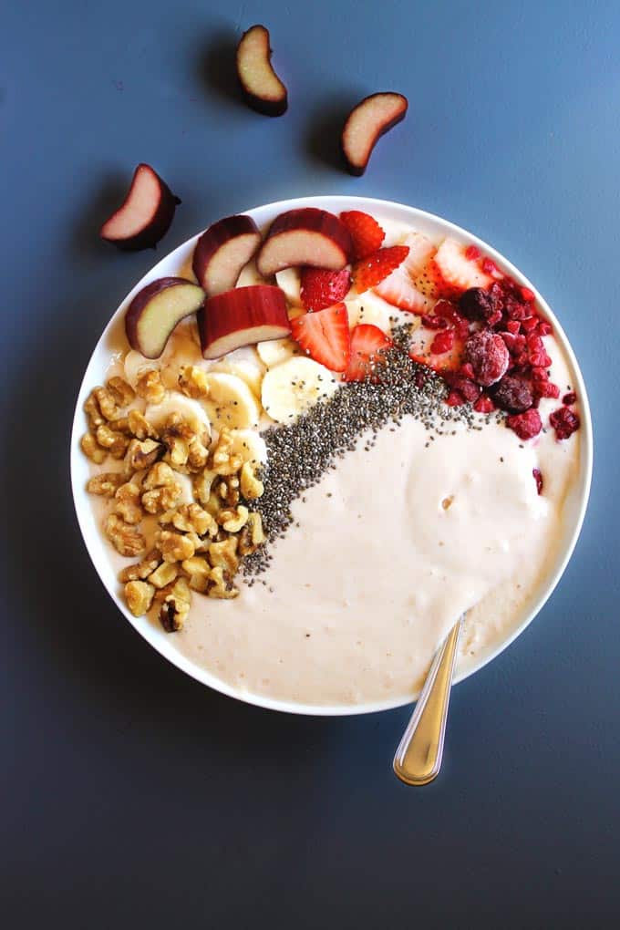 Honey roasted rhubarb smoothie bowls recipe! Tart rhubarb is roasted in sweet honey, then blended with yogurt and topped with all the smoothie bowl fixins. Such a healthy and beautiful breakfast! Vegetarian, gluten free, refined sugar free.
