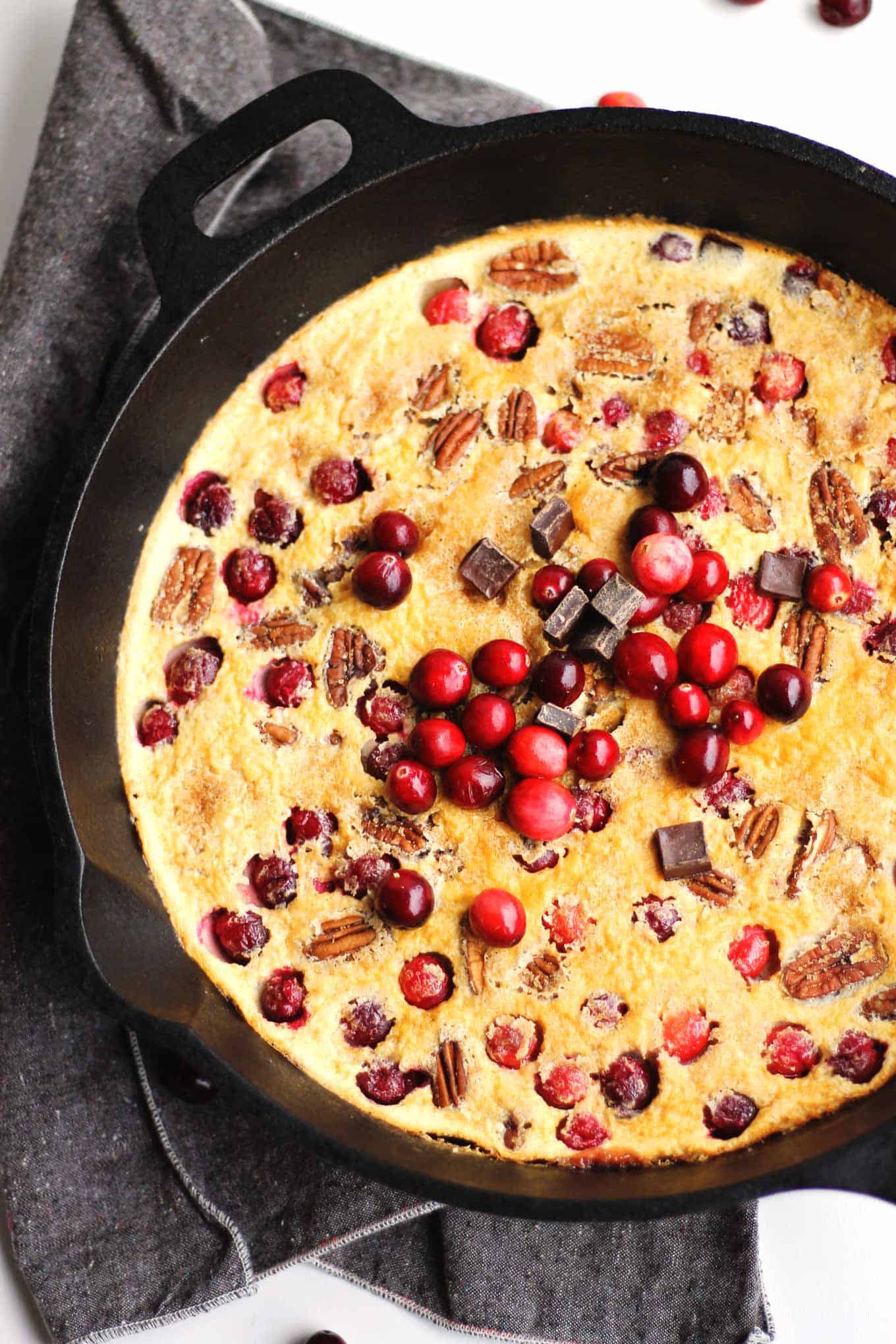 Cranberry clafoutis with dark chocolate and pecans! Easy blender recipe for the classic French custardy breakfast, with a holiday spin. Eat dessert for breakfast! - Rhubarbarians