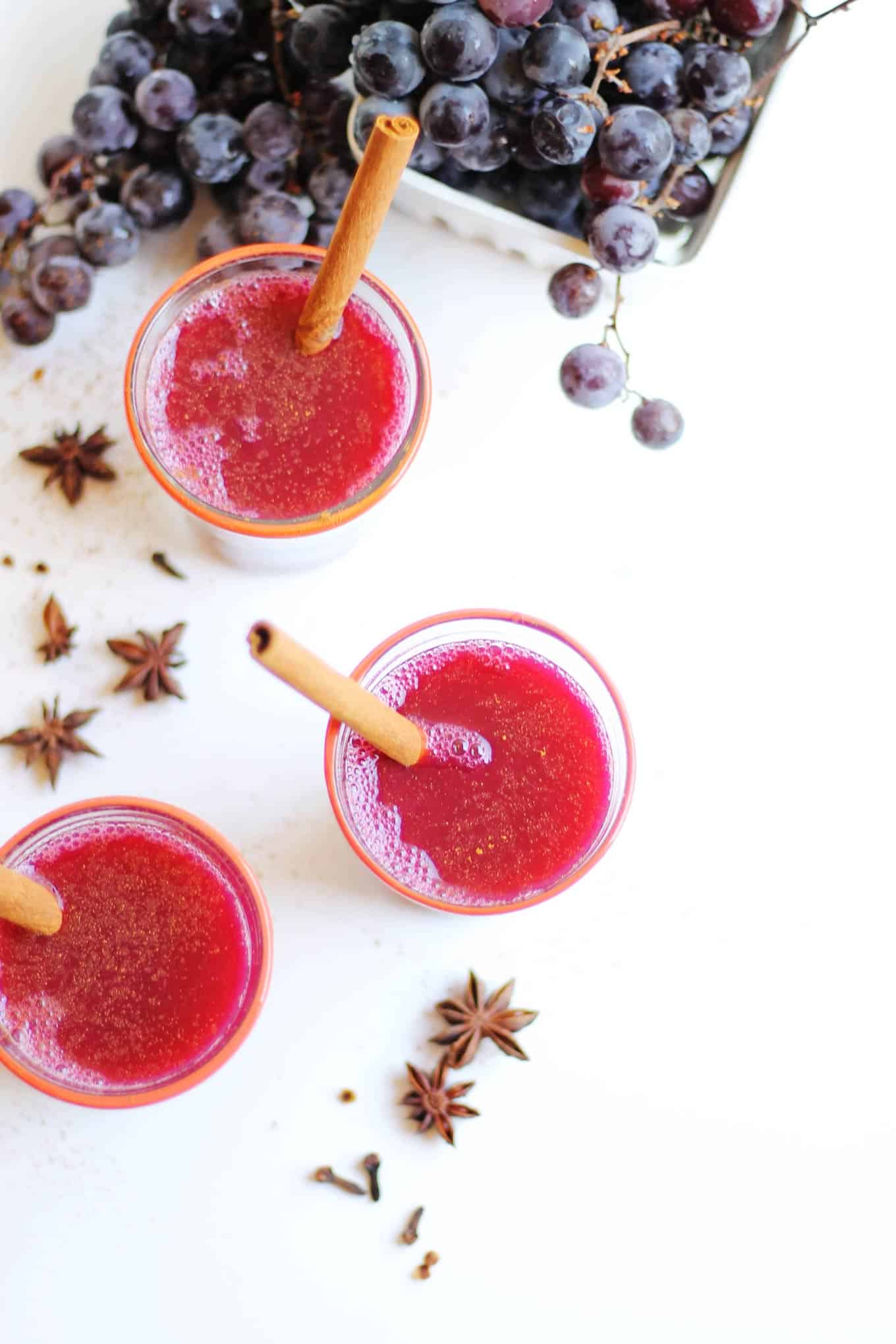 30 minute mulled concord grape cider recipe! Make a batch on your stovetop and make your house smell like fall! Sweet enough without any sugar added. The perfect drink for your fall party, or just getting cozy. Naturally vegan and refined sugar free. // Rhubarbarians #grapecider #falldrink