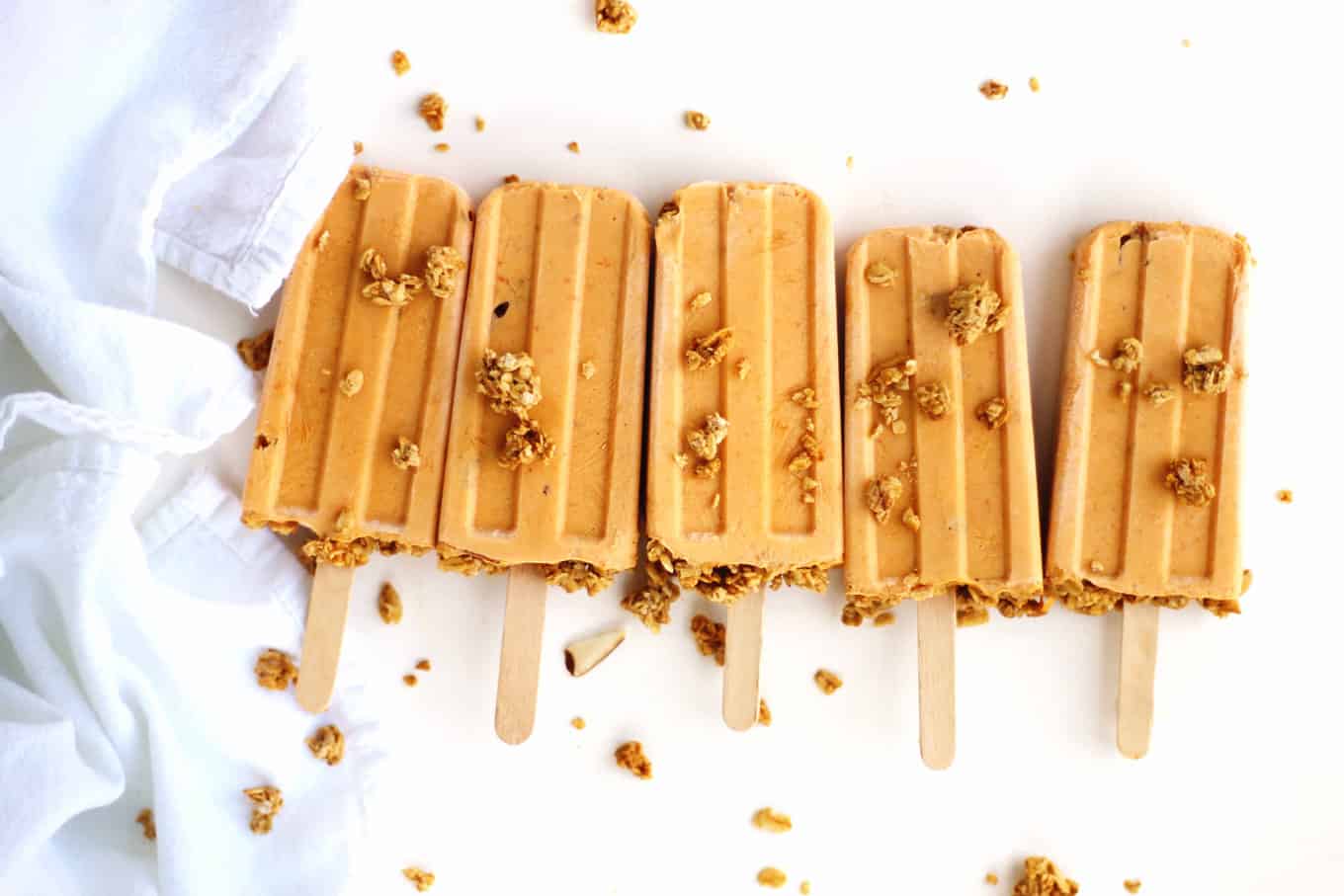 Pumpkin popsicles with scattered granola
