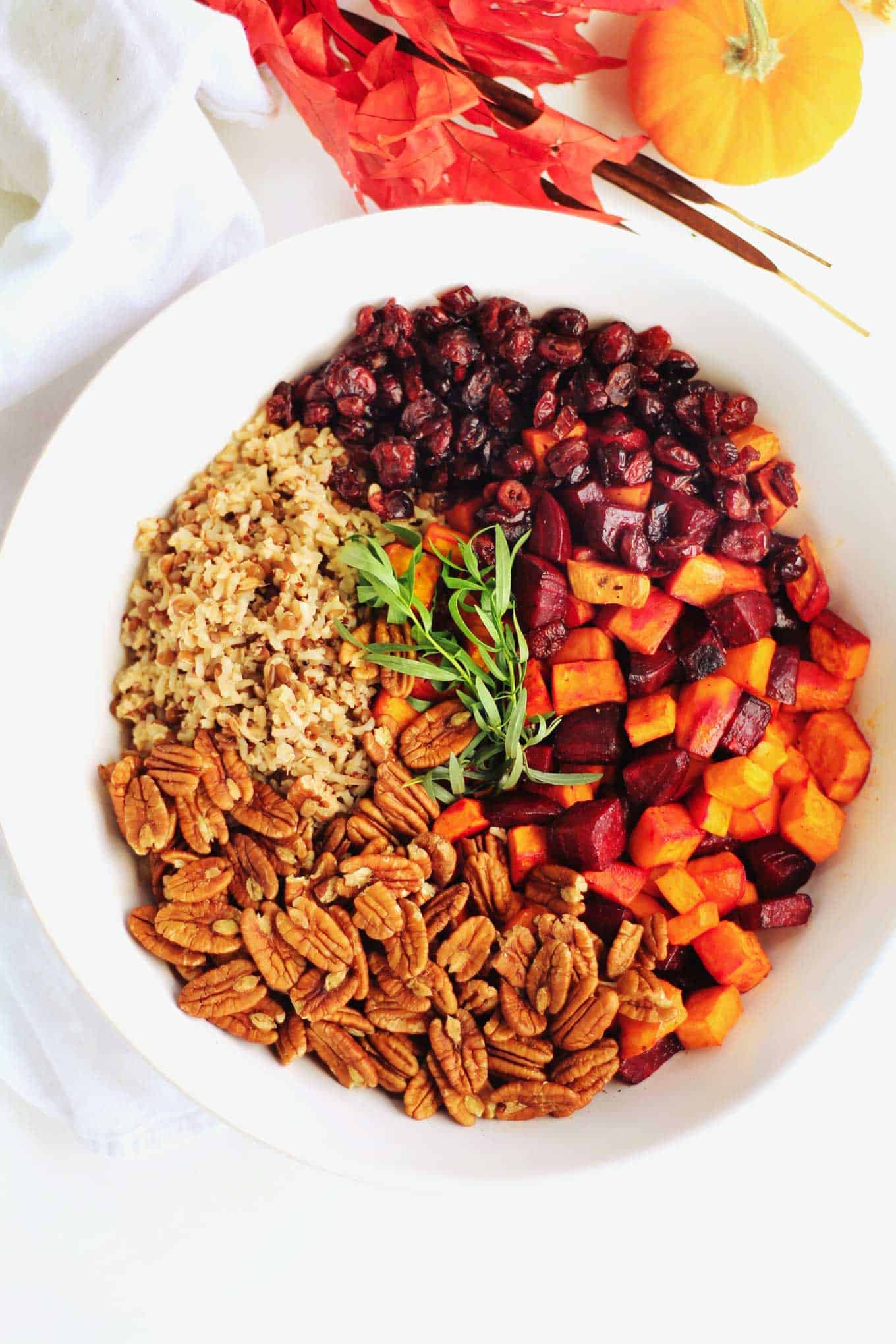 A photo of a root vegetable fall wild rice salad in a white bowl