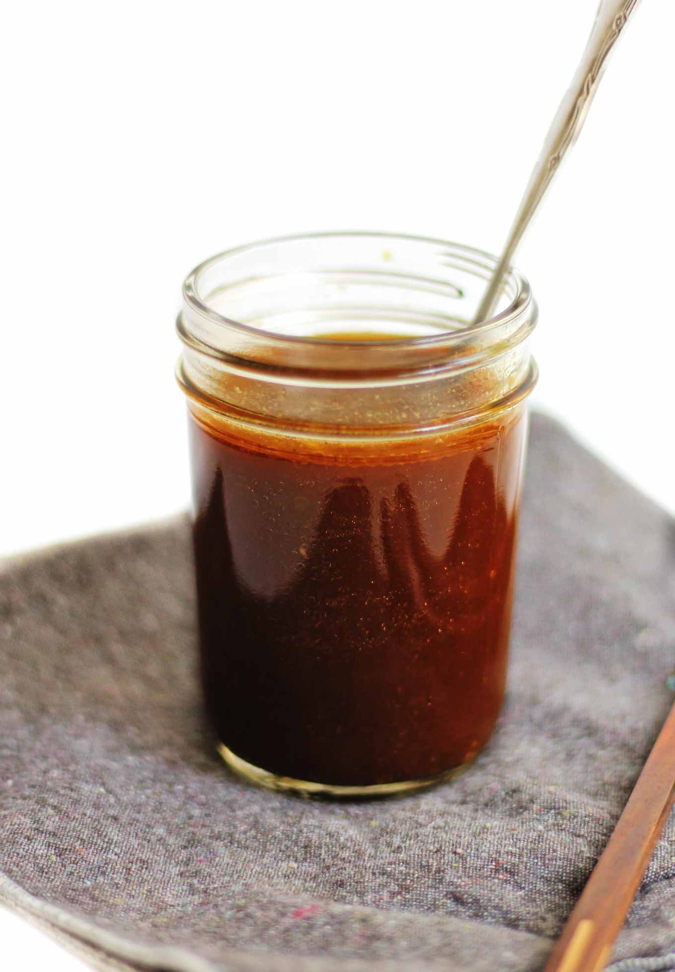 vegan stir fry sauce recipe in a mason jar with a spoon