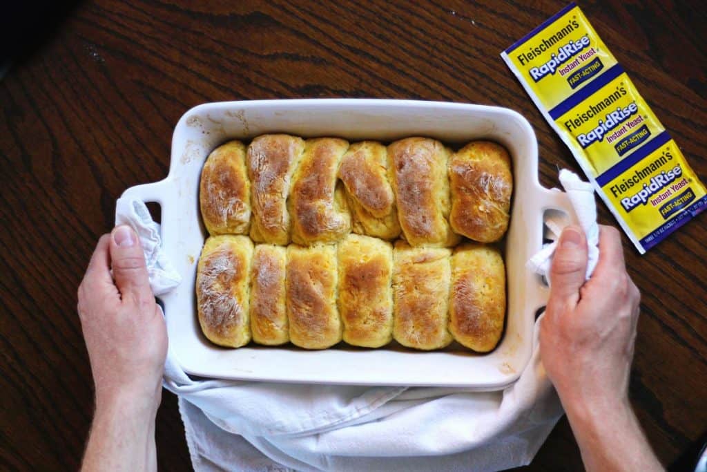 Pan of homemade dinner rolls with yeast packet