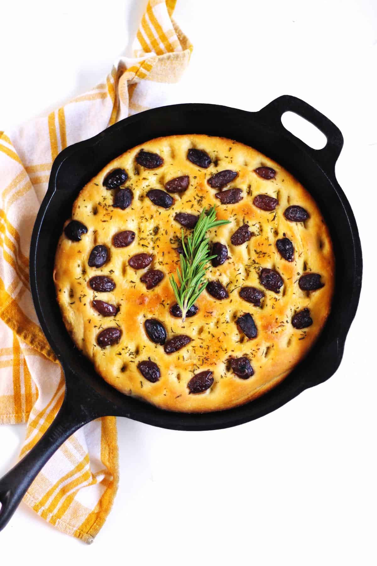 focaccia bread in a skillet with rosemary