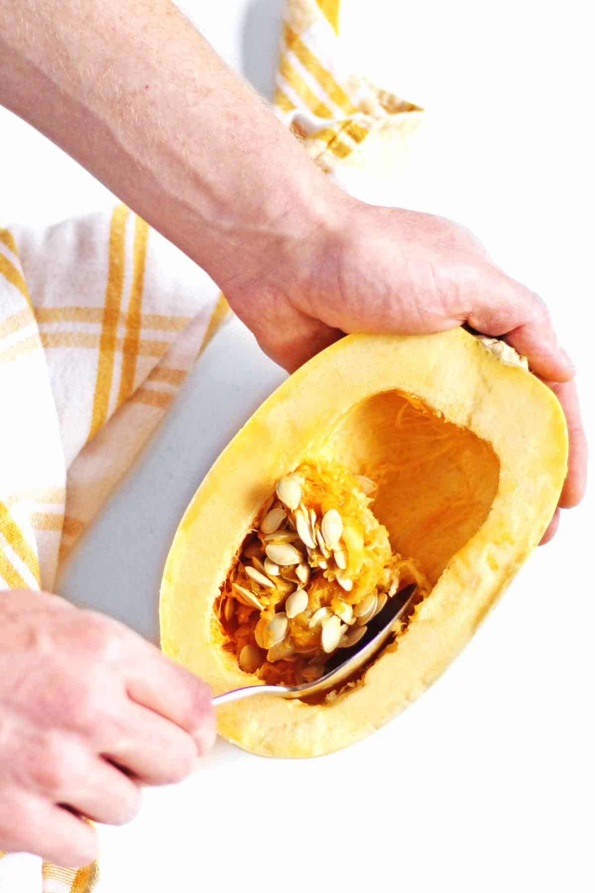 scooping seeds spaghetti squash