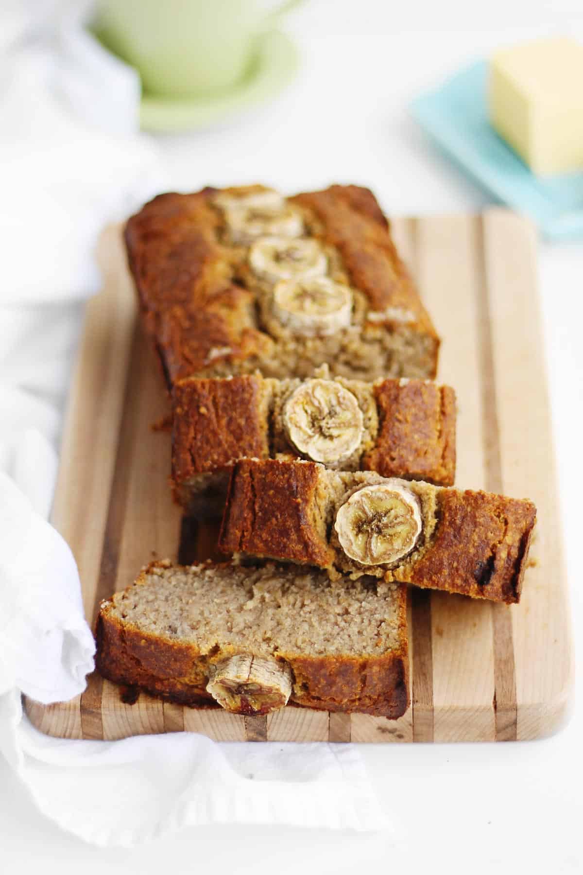 A photo of slices of banana bread on a cutting board.