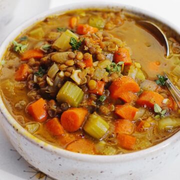 Pumpkin lentil soup with a spoon