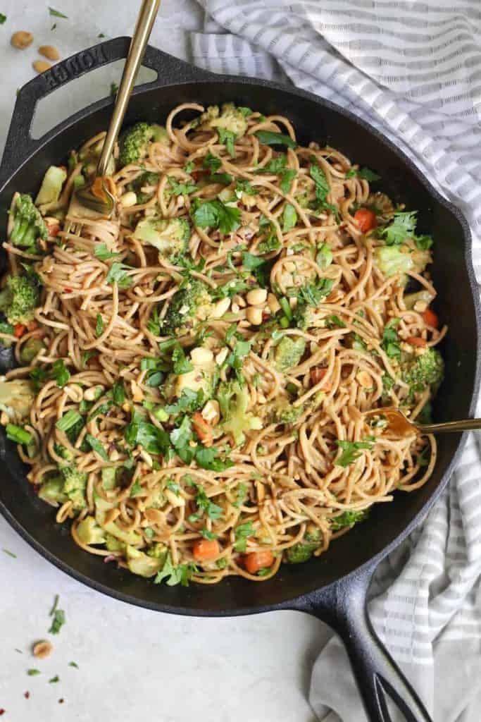 Peanut noodles and broccoli in a skillet