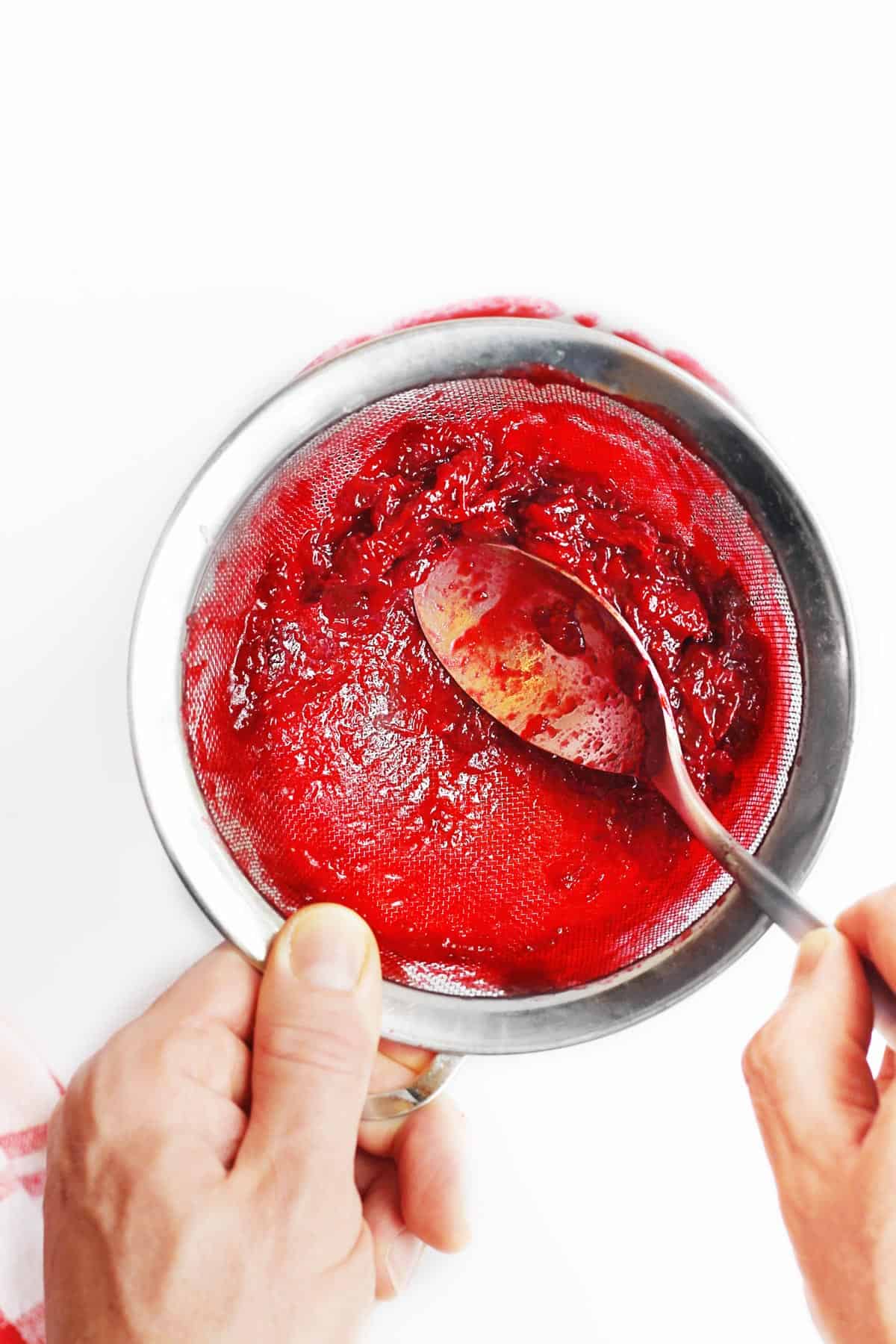 Pressing cranberries for cranberry glaze