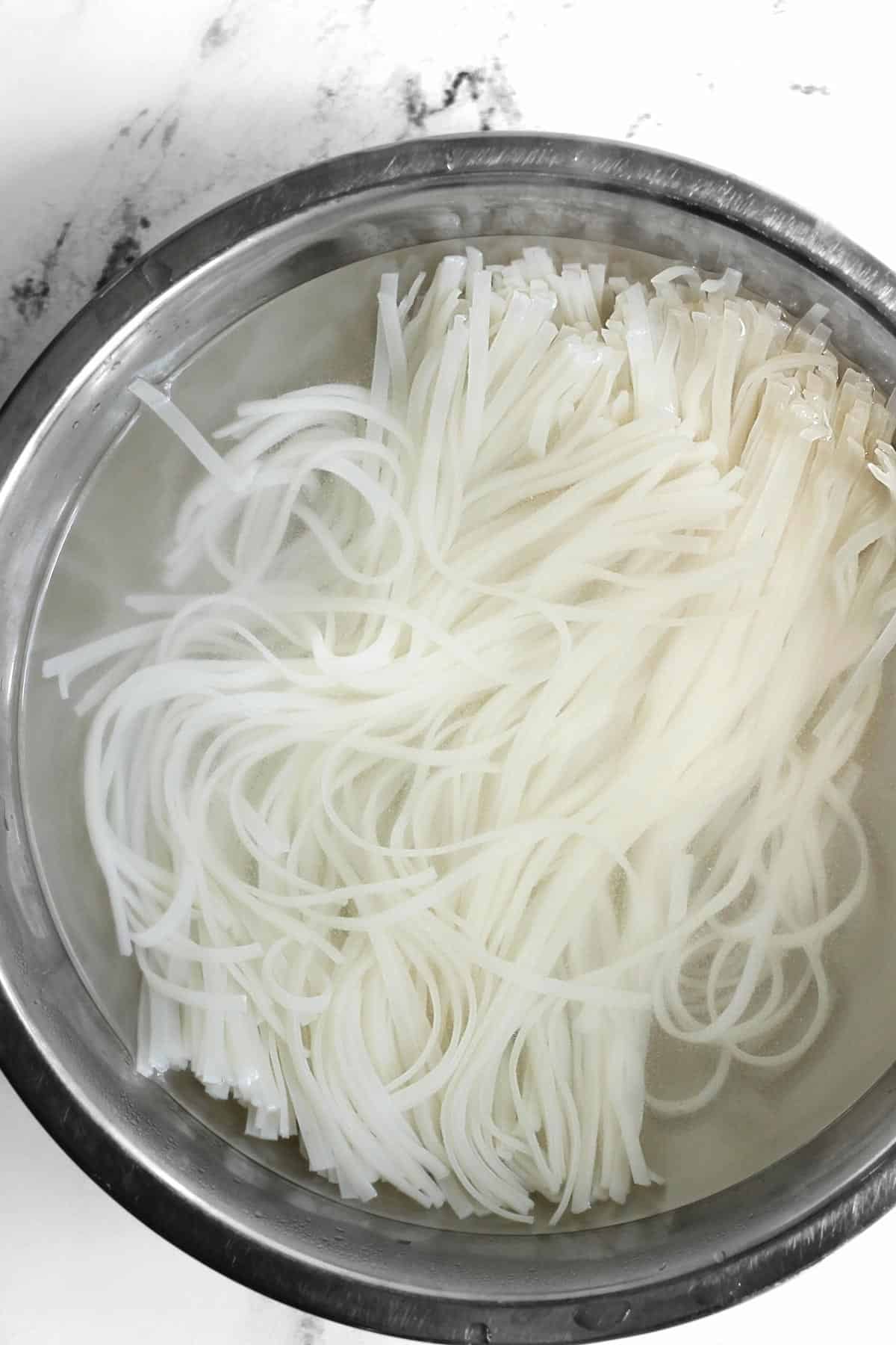 Rice noodles soaking in boiling water