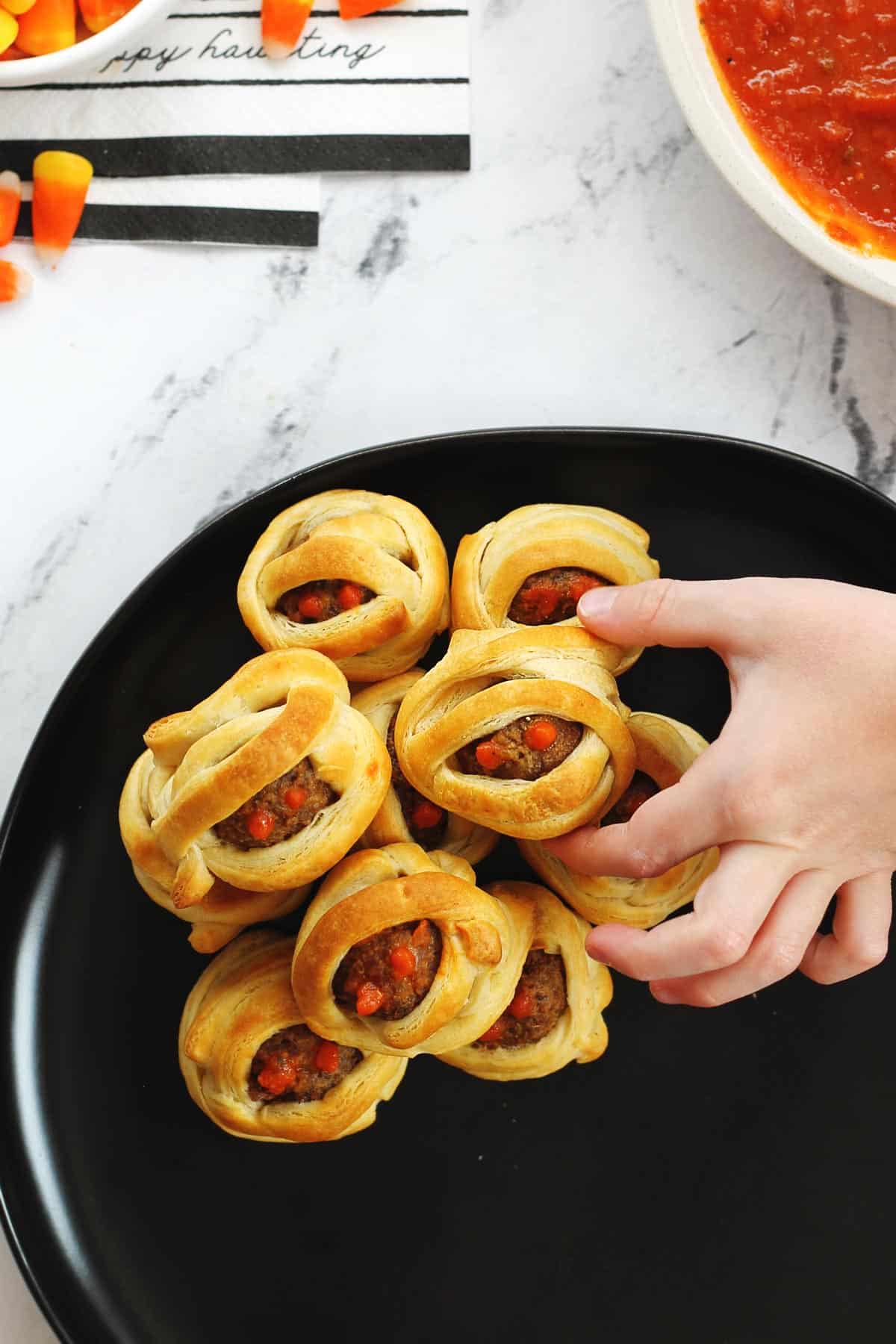 Halloween meatballs with a hand