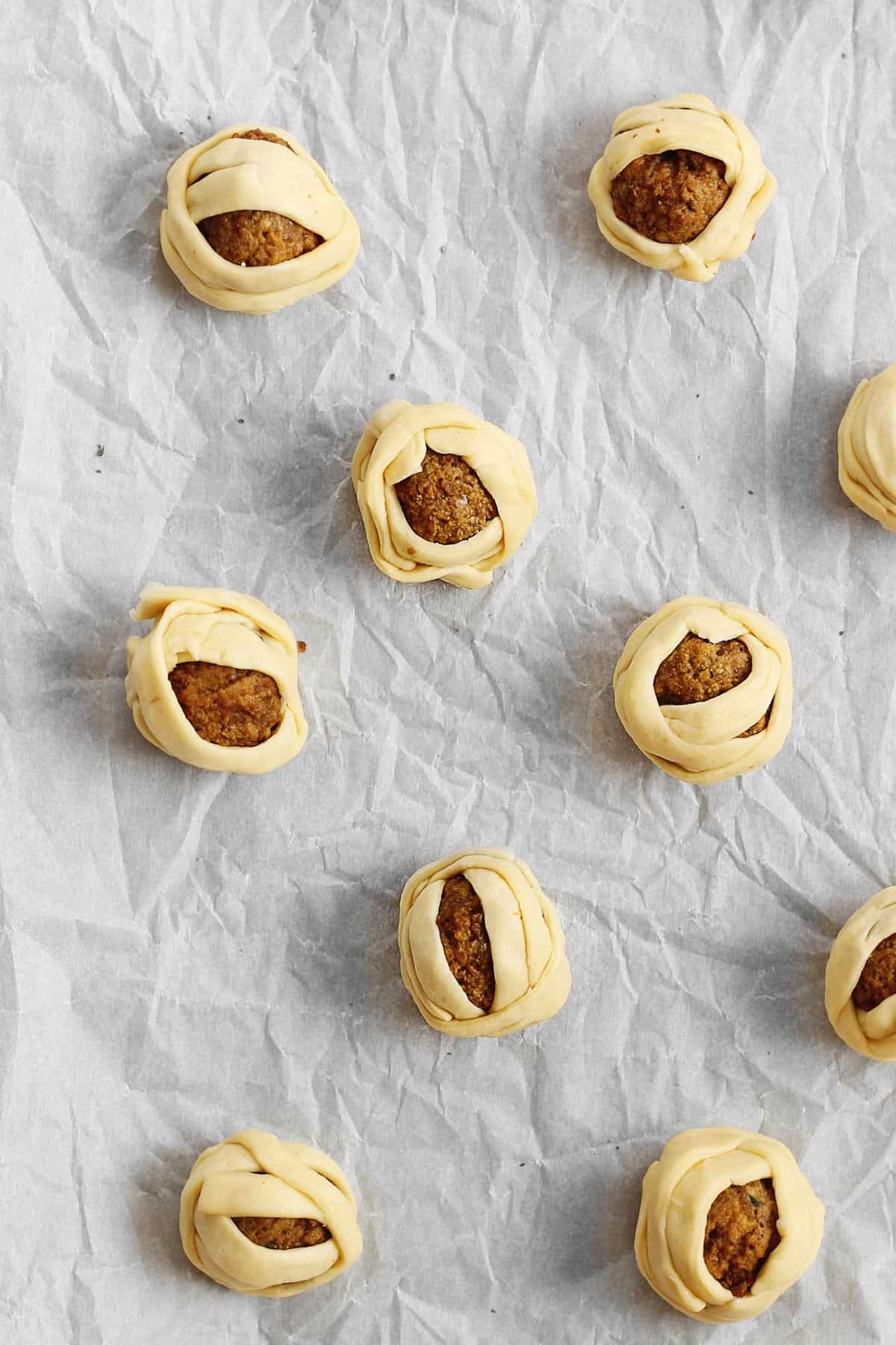 Mummy meatballs on a baking sheet