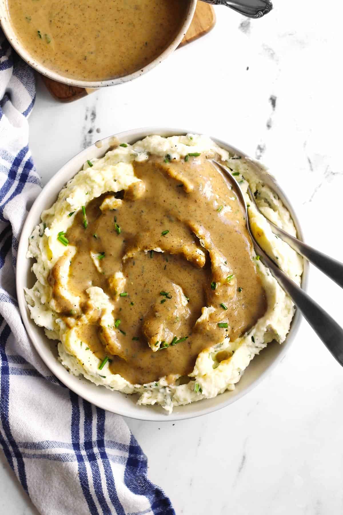 Mashed potatoes and gravy with 2 spoons