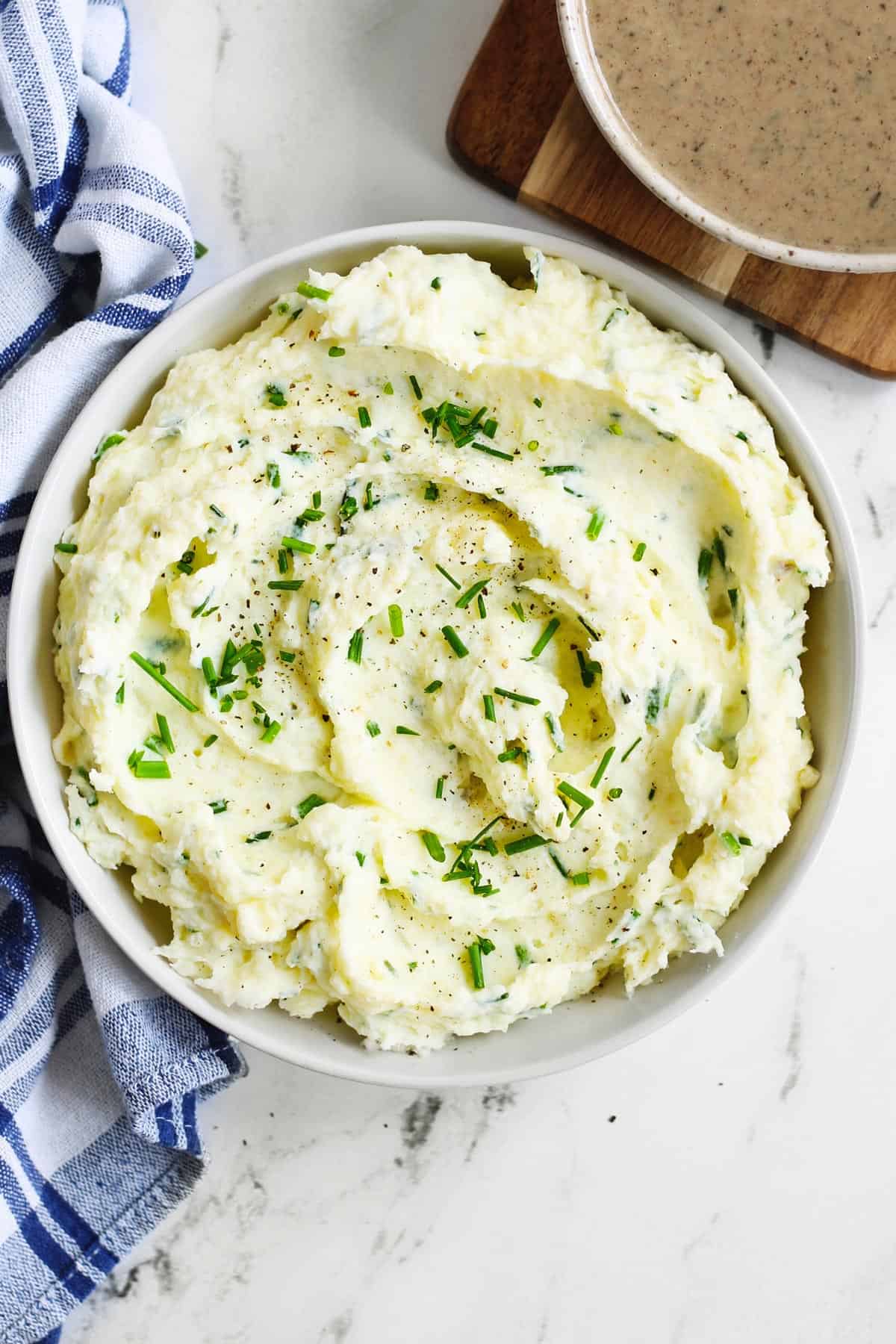 Sour cream and chive mashed potatoes in a white bowl
