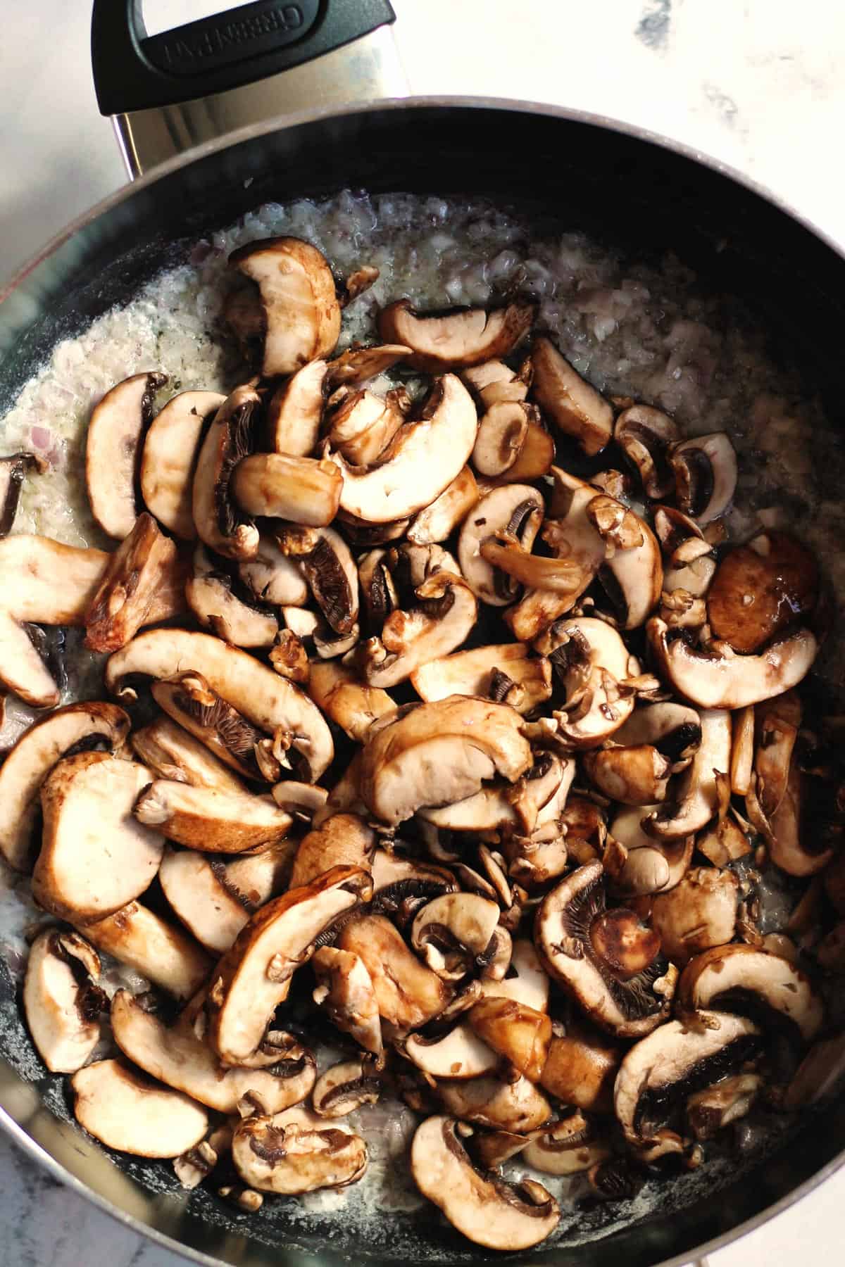 Cooking sliced mushrooms in a skillet