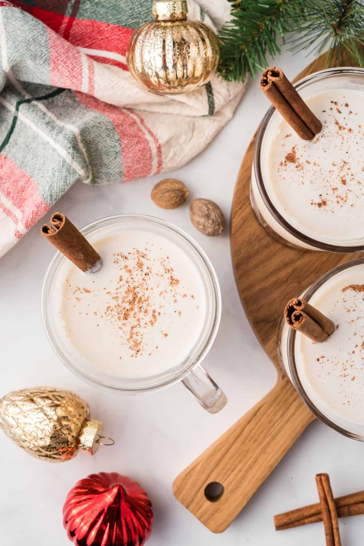 Spiked eggnog with a christmas scene background