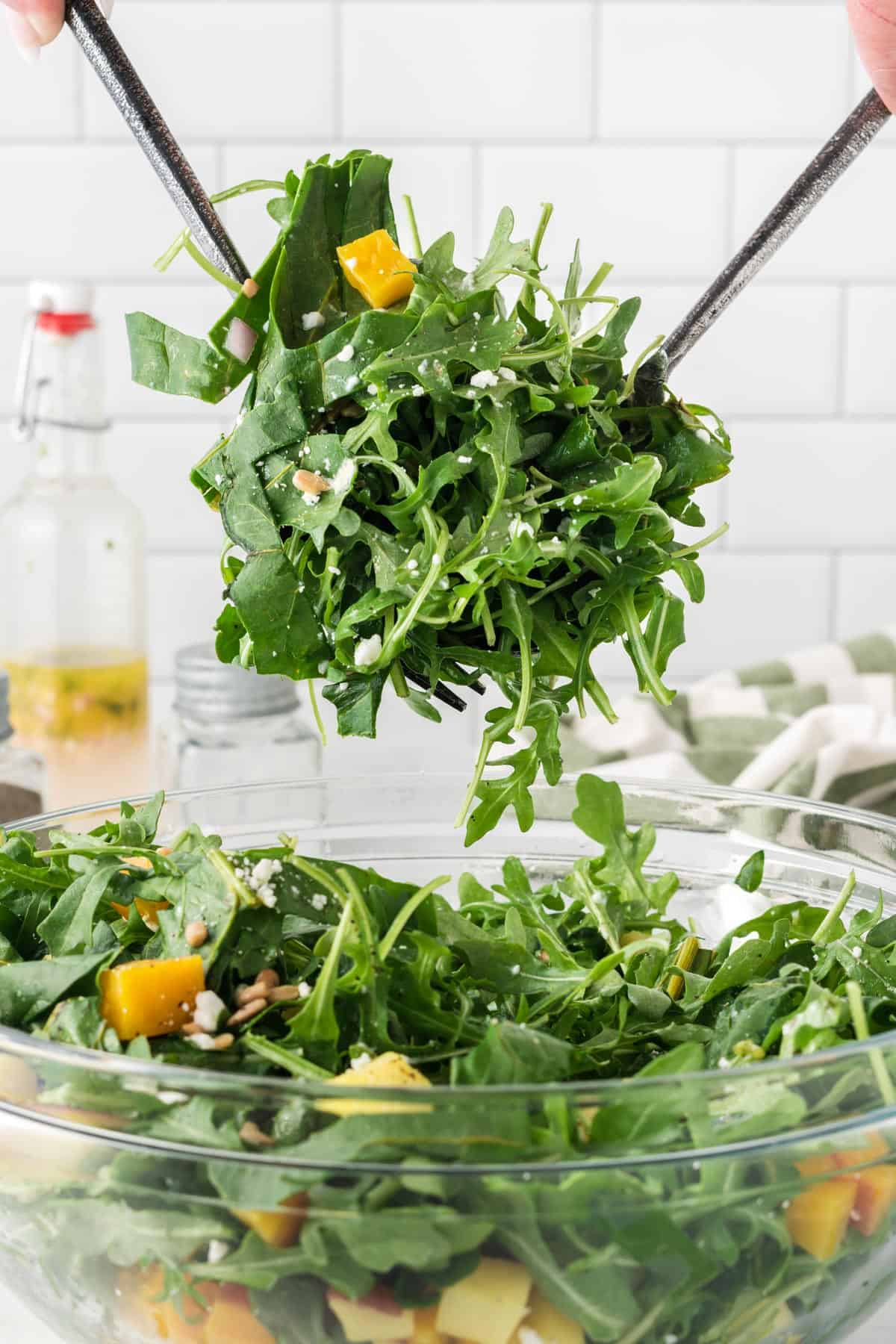 A picture of scooping up salad with arugula and yellow beets
