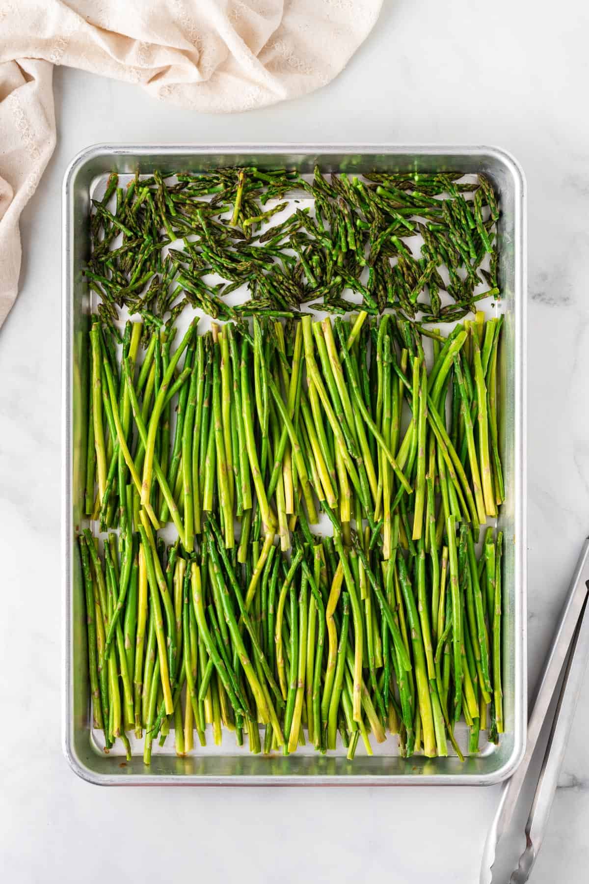 A picture of roasted asparagus on a metal sheet pan.