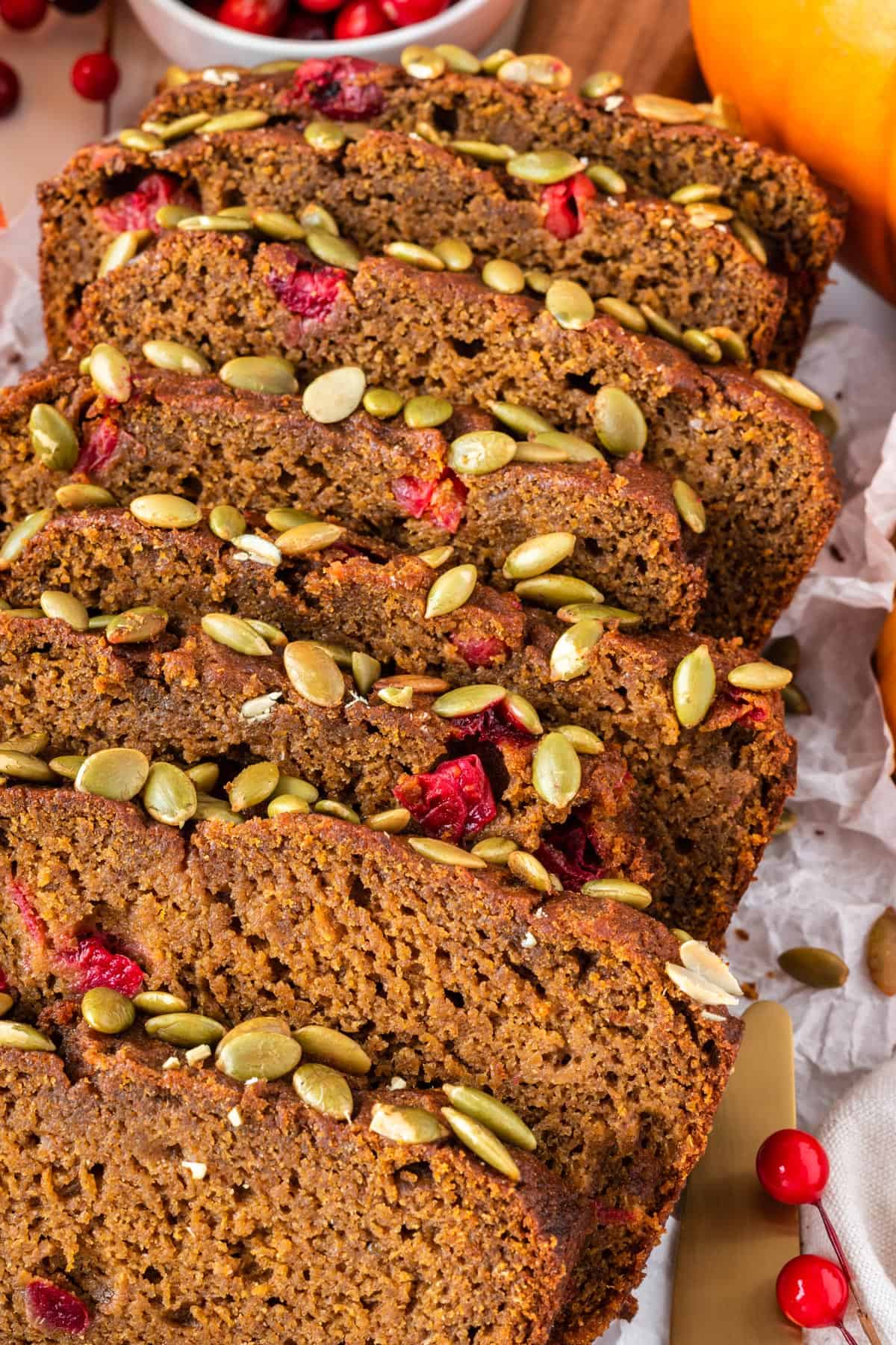 A close up photo of slices of pumpkin cranberry bread.
