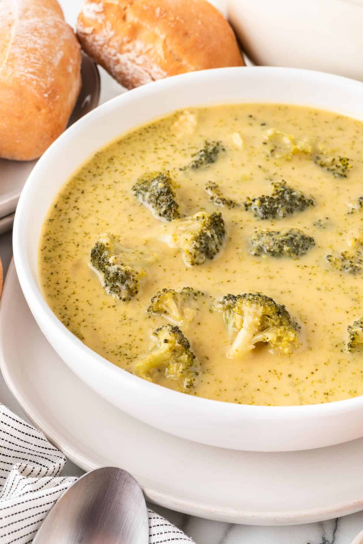 A photo of the left side of a bowl of broccoli soup.