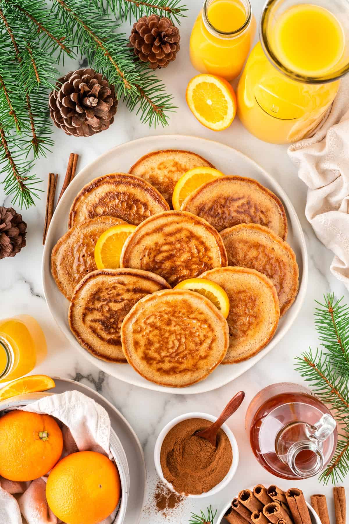 A photo of a platter of small orange pancakes.