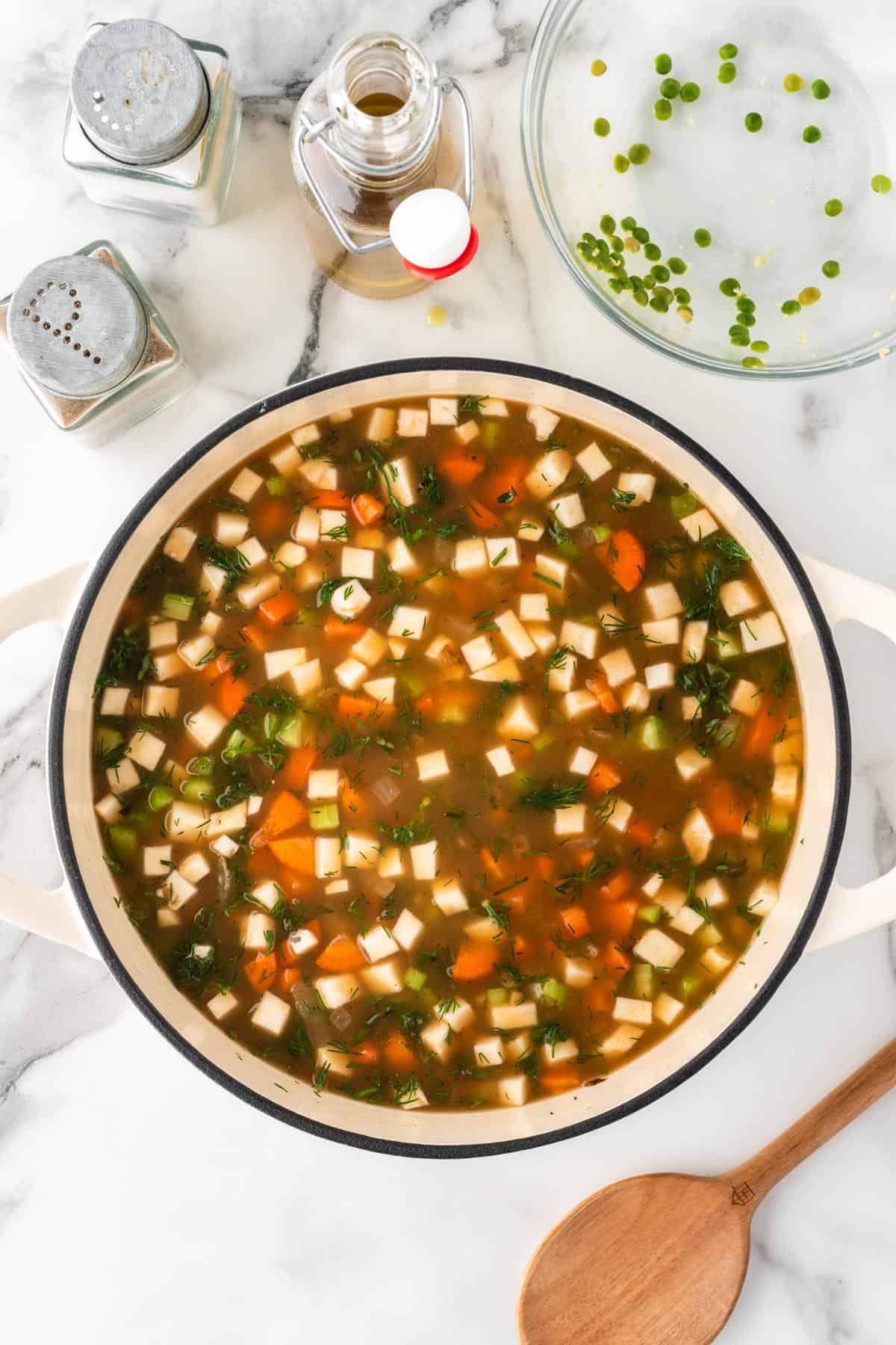 A photo of split pea vegetable soup in a cooking pot.