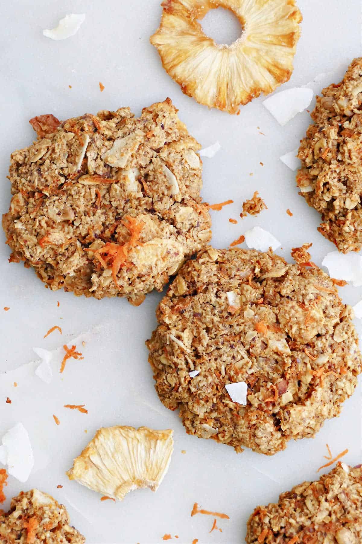 A photo of two morning glory cookies on parchment paper.