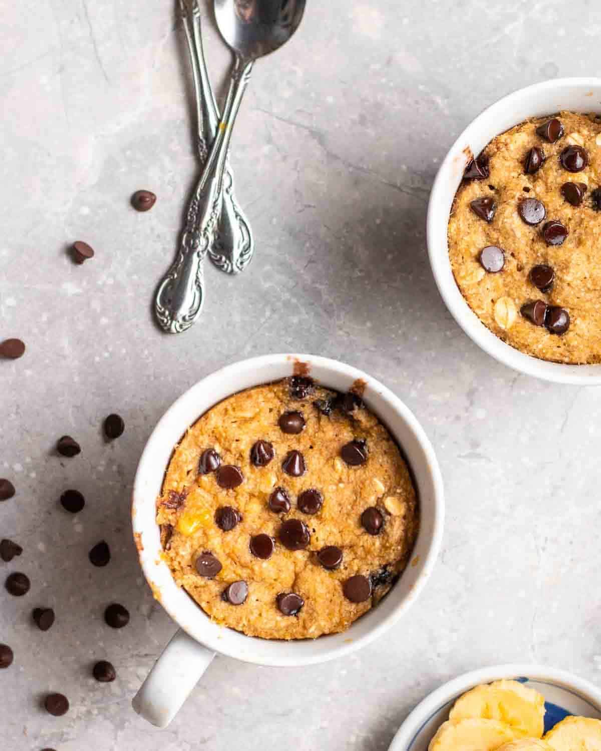 A photo of a mug cake with chocolate chips.