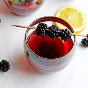 A square photo of a blackberry summer whiskey cocktail.
