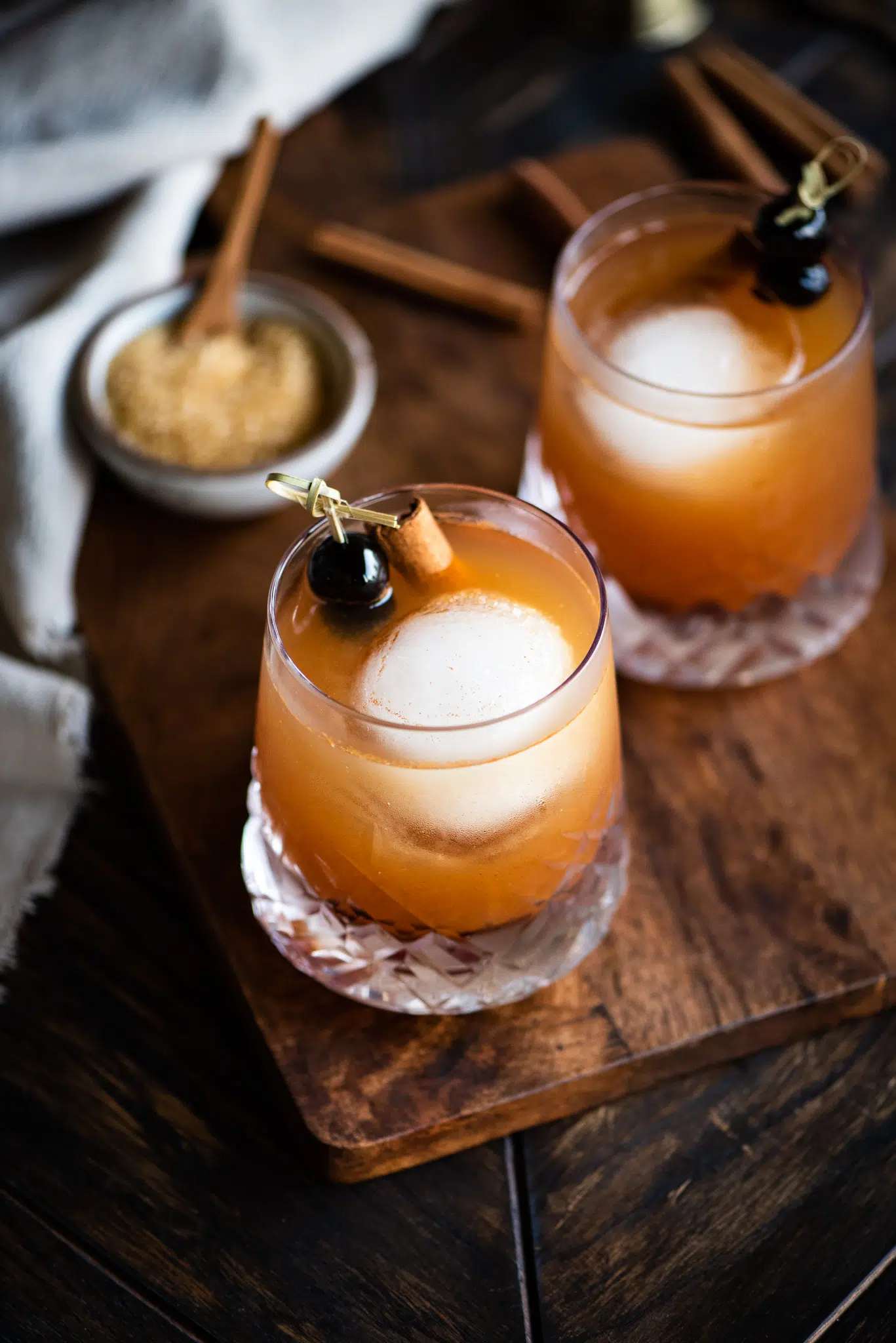 A photo of two cinnamon maple whiskey sour cocktails.