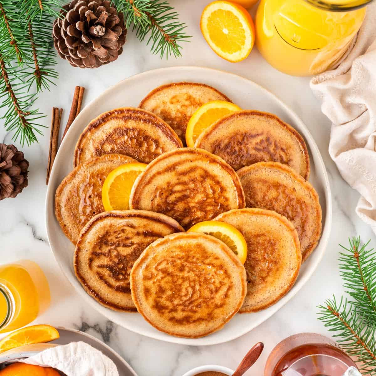 A square photo of a platter of orange pancakes for Christmas.